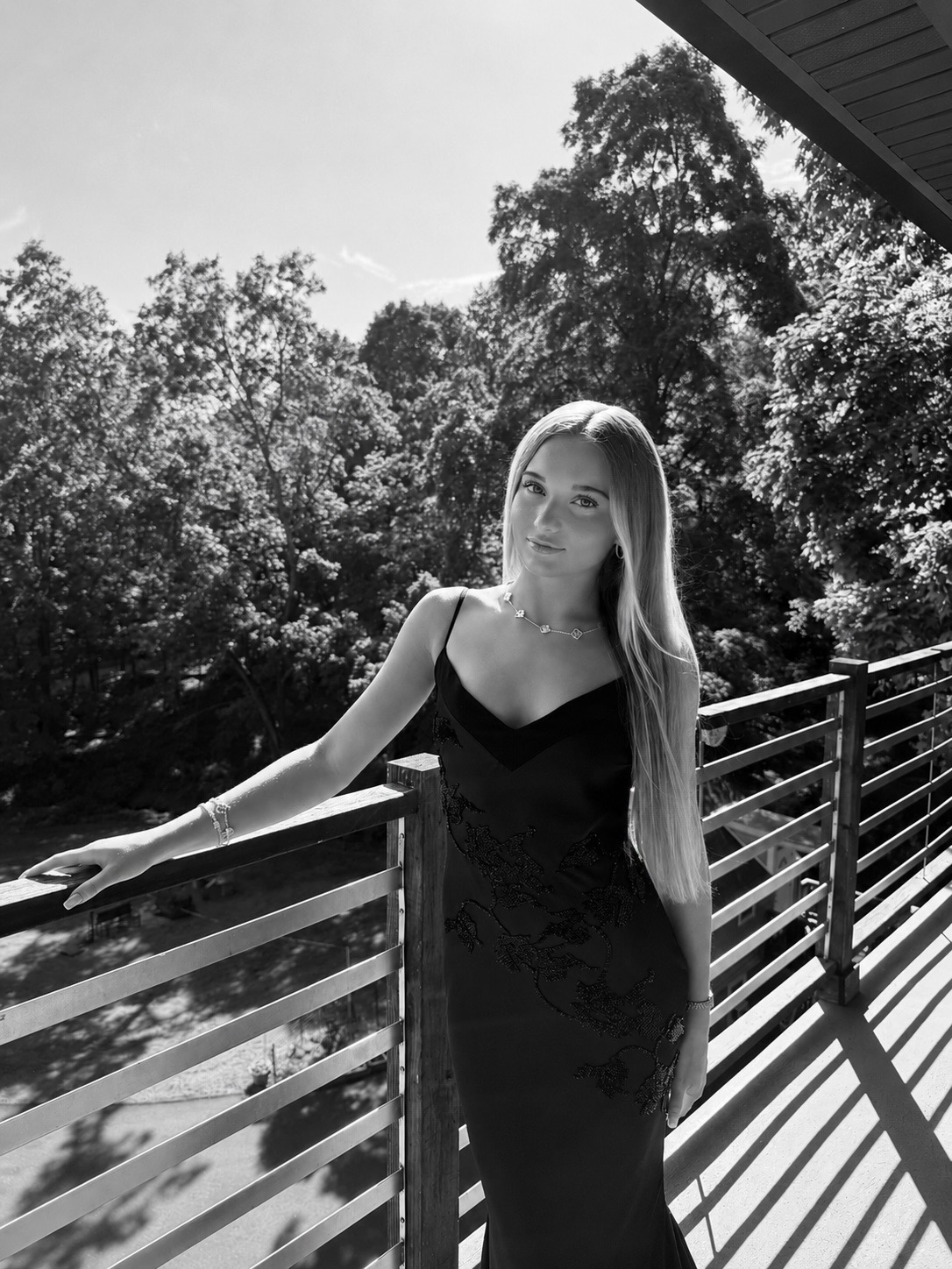 Black and white portrait of Camelia, the author of The Life Playbook, on an outdoor deck